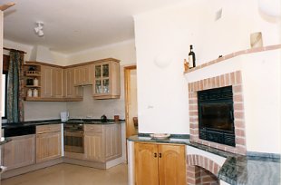 The Kitchen including a wood burning fireplace